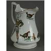 Image 1 : A 19th century pottery puzzle jug with two transfer printed harlequins and three cock fighting sc...