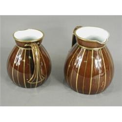 Two Rockingham jugs, each with gilt lining on brown glazed bodies, bases with Griffin marks, tall...