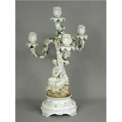 A mid 19th century continental porcelain four branch figural candelabra, decorated in pale colour...