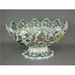 A late 19th century Le Nove tin glazed Monteith, decorated throughout with polychrome floral spra...