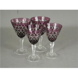A set of sixteen Stephens & Williams amethyst coloured cut wine and sherry glasses, etched marks...