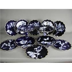 A twelve piece continental porcelain dessert service, circa 1900, with insect and flower decorati...