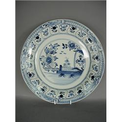 A 19th century Dutch Klaw blue and white charger, decorated with a floral centre and banding, mar...