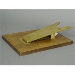 A novelty gilt metal and walnut paper clip in the form of a bootjack, 24cm long Est. 100/150...