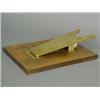 Image 1 : A novelty gilt metal and walnut paper clip in the form of a bootjack, 24cm long Est. 100/150...