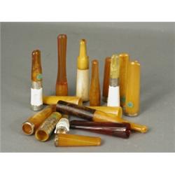 Sixteen amber cigar holders, some with gold and silver mounts Est. 150/180...