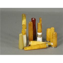 Twelve amber cigar holders, some with gold and silver mounts Est. 100/150...