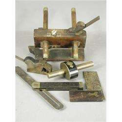 Five woodworking tools: A gun metal bullnose plane, a brass and ebony splitting gauge, a plough p...