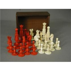 An ivory chess set in natural and red stained ivory, complete, king 8cm high Est. 270/350...