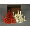 Image 1 : An ivory chess set in natural and red stained ivory, complete, king 8cm high Est. 270/350...