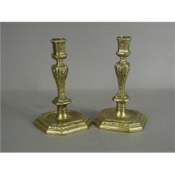 A pair of French Regency brass candlesticks of square form Est. 400/500...
