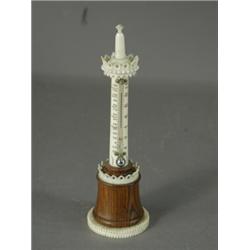 An ivory tower thermometer with wooden mounts, 17cm high, (thermometer broken) Est. 100/150...