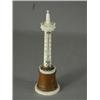Image 1 : An ivory tower thermometer with wooden mounts, 17cm high, (thermometer broken) Est. 100/150...