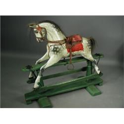 A carved wood and gesso rocking horse by F. H. Ayres, circa 1900, the head swivelling, on a stati...