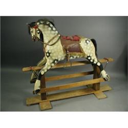 A carved wooden rocking horse, circa 1950's with a horse hair main and tail, on static testle roc...