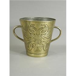 An Arts and Crafts brass ice bucket with two embossed bouquets of tulips on a hammered ground, c/...