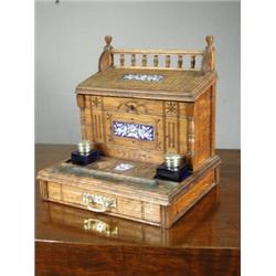 An oak 'Aesthetic' movement enamel panelled desk stand with associated inkwells, 29cm Est. 250/30...