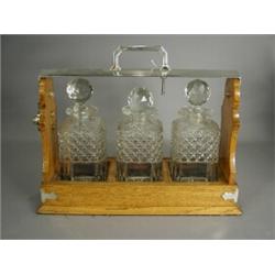 A Victorian/Edwardian tantalus with three cut glass decanters and plated mounts Est. 200/300...