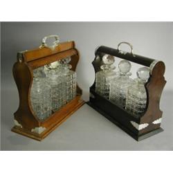 Two tantalus with matched and moulded decanters Est. 200/300...