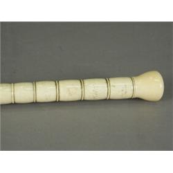 A turned bone walking cane with an ebonised wooden foot, 103cm high Est. 200/300...