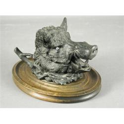 An inkwell in the form of a boar's head, on an oval plinth base, 22cm (with pottery well) Est. 10...