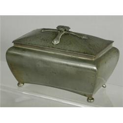 A Liberty pewter box, the domed lid with an applied cross and finial with stylised flowers, on bu...