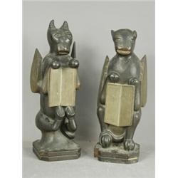 A pair of carved grotesque statues holding books, 37cm Est. 200/250...