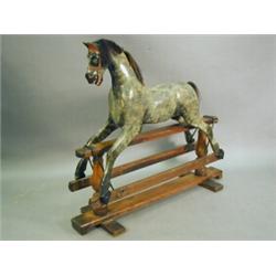 A late Victorian/Edwardian rocking horse, 130cm wide Est. 300/500...