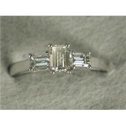 A baguette diamond three stone ring set in 18ct white gold, size O 1/2 Est. 500/700...