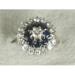 A sapphire and diamond cluster ring set with a central diamond of approx 0.25ct and seventeen out...