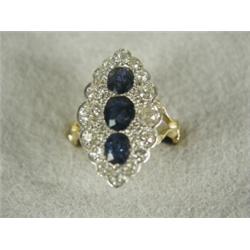 A Victorian sapphire and diamond marquise ring in a yellow gold engraved shank with split shoulde...