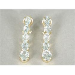 A pair of aquamarine drop earrings, each consisting of five graduated oval faceted aquamarines se...