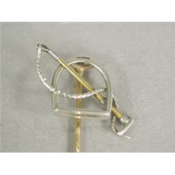 A gold hunting tie pin in the form of a stirrup and a whip, 8cm long Est. 80/120...