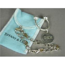 Two silver Tiffany & Co items: a key ring (removable tag engraved DKH), and a bracelet heightened...