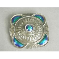 A good Liberty & Co silver brooch with enamelled corners, ropework borders and repousse decoratio...