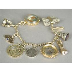 A 9ct gold curb link charm bracelet with nine various charms, 19cm long Est. 150/200...