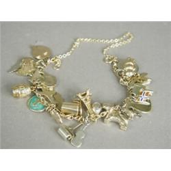 A 9ct gold fetter and rope link charm bracelet, with thirty one various charms, 19cm long Est. 15...