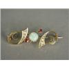 Image 1 : A 15ct gold bar brooch set with an opal, rubies and seed pearls, 4cm long Est. 70/100...