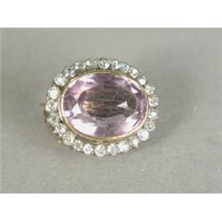 A Victorian amethyst and diamond cluster brooch, the bazel set amethyst surrounded by 25 eight-cu...