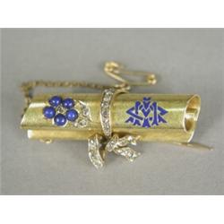 A yellow metal (tests at least 18ct) brooch in the form of a scroll, set with a lapis lazuli and...