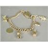 Image 1 : A 9ct gold curblink charm bracelet with six various charms, a heart locket and safety chain, 18cm...