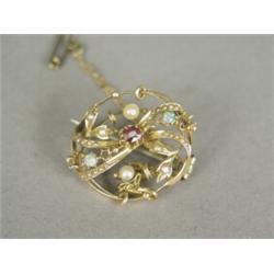 An antique 14ct gold brooch set with a ruby, two opals and seed pearls, 2.5cm long, with a safety...