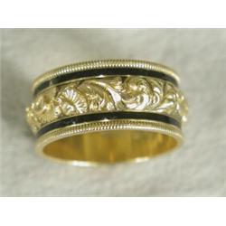 A George V 18ct gold mourning ring with a central engraved and embossed foliate band within black...