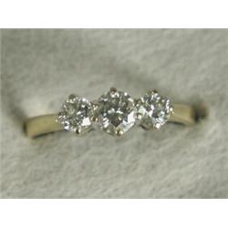 A three stone diamond ring set in 18ct gold, size M 1/2 Est. 450/550...