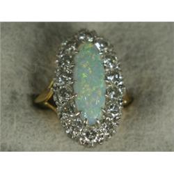 An opal and diamond marquise cluster ring size L 1/2 (opal 16 x 6mm, total diamond weight approx...