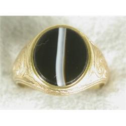A 19th century yellow metal (tests 18ct) signet ring set with banded agate, within engraved shoul...