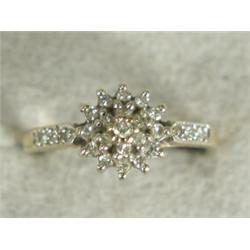 A diamond cluster ring with diamond set shoulders, set in 9ct gold, size I 1/2 Est. 75/100...