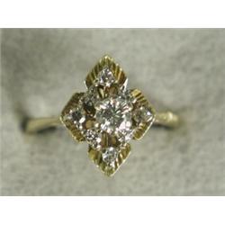A diamond dress ring with a central stone of approx 0.25ct within a border of smaller stones, set...