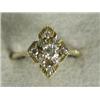 Image 1 : A diamond dress ring with a central stone of approx 0.25ct within a border of smaller stones, set...