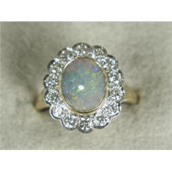 A diamond and opal cluster ring, size O 1/2 (Total diamond weight approx 1ct) Est. 900/1000...